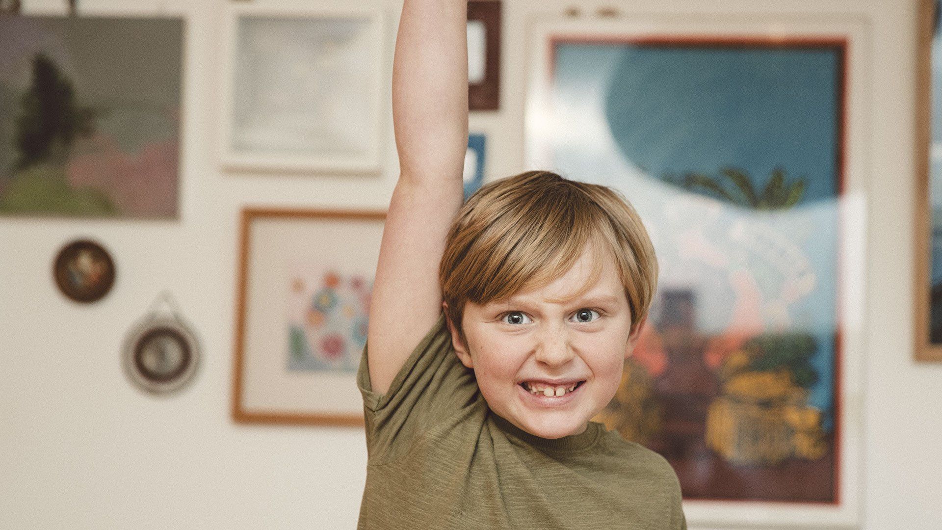 Portrait of a boy with his hand up